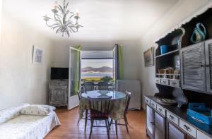 a living room with a table and chairs and a couch at Studio pieds dans l'eau in Grosseto-Prugna