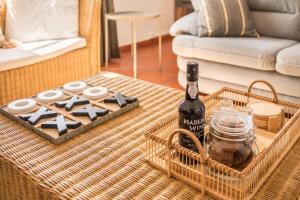 a bottle of wine on a table in a living room at Casa da Olides - T3 in Santana