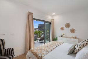 a bedroom with a bed and a balcony at Yucas Villa 17 in San Bartolomé +24 photos