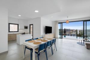 a kitchen and dining room with a table and chairs at Yucas Villa 17 in San Bartolomé