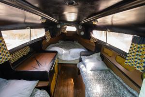 a small room with two beds in a van at la pêcherie in Malbosc +12 photos