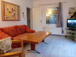a living room with a couch and a table at Ferienhaus Schatz in Siedlung Schönwalde