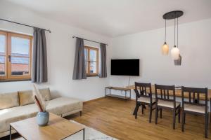 a living room with a table and a dining room at Ferienwohnung Maria in Gilching