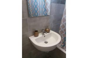 a bathroom with a sink and a mirror at Μaria's house 1 in Ilia