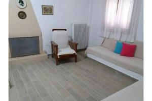 a living room with a couch and a chair at Μaria's house 1 in Ilia