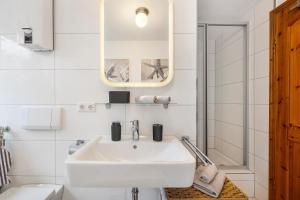 a white bathroom with a sink and a toilet at Hannover Südstadt-Perle in Hannover +14 photos