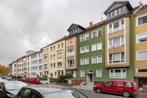 a row of buildings on a street with parked cars at Hannover Südstadt-Perle in Hannover