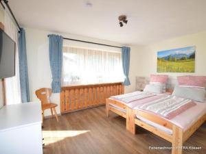 a bedroom with a large bed and a window at Ferienwohnung Petra in Kössen