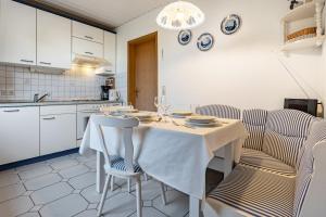a kitchen with a table with two chairs and a table at Haus Seeblick in Putbus