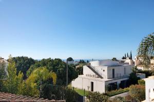 a view of a white house with trees at Villa Rústica in Albufeira