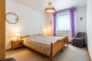 a bedroom with a large bed and a window at Haus Seeblick in Putbus