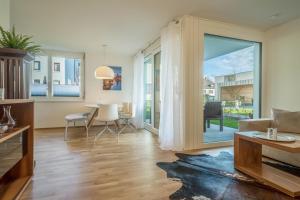 a living room with a large sliding glass door at Sunny Appartment in Bregenz