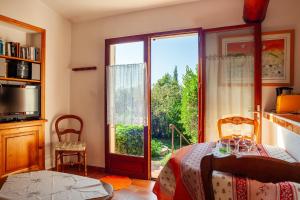 a bedroom with a bed and a large window at Les Oiseaux in Ceyreste