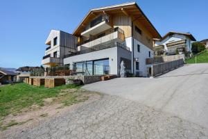 a house with a large driveway in front of it at Moarhof in Meltina