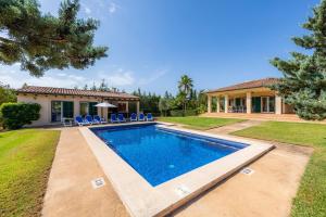 a home with a swimming pool and a house at La Vinya del Beato 1950 in Port de Pollensa
