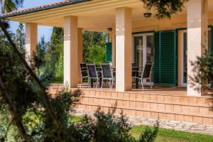 a house with chairs on the front porch at La Vinya del Beato 1950 in Port de Pollensa