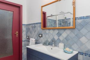 a bathroom with a sink and a mirror at Maison Chloe 2 in La Maddalena +17 photos