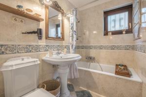a bathroom with a sink and a toilet and a tub at Carmen San Andrés in Granada +37 photos