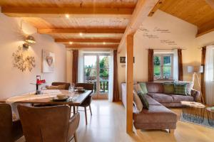 a living room with a couch and a table at Ferienwohnung Rauschberg in Ruhpolding