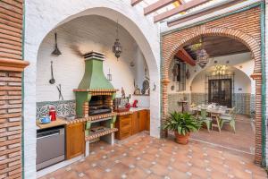 an outdoor kitchen with an oven and a table at Carmen San Andrés in Granada