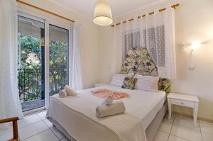 a bedroom with a bed and a large window at S6 apartment in Nikiana