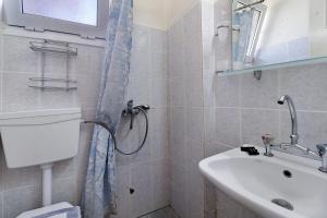 a bathroom with a shower and a sink at S6 apartment in Nikiana