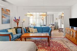 a living room with a blue couch and a table at Villa Cempo V215 in La Cala de Mijas