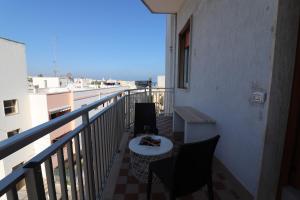 a balcony with a table and chairs on a building at Casa Vacanze Nike a Otranto in Otranto