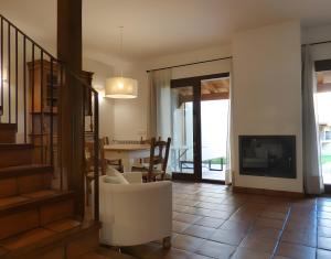 a living room with a table and a fireplace at Casa Rural Fuentebuena in Matabuena