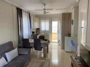a living room and kitchen with a couch and a table at Alberca La Nucia in Polop