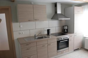 a kitchen with a sink and a stove at Ferienwohung Stelldichein in Altenbrak +25 photos