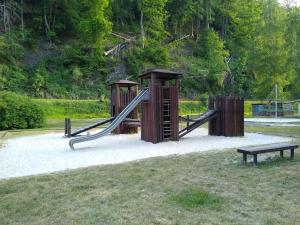a playground with a slide and a bench in a park at Ferienwohung Stelldichein in Altenbrak