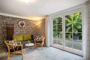 a living room with a couch and chairs and a window at Ferienwohnung For two in Mahlberg