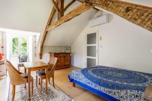 a bedroom with a bed and a table and chairs at Chambre d'hôtes Kerdary in Nivillac