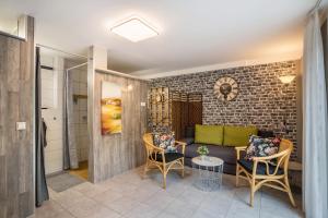 a living room with a couch and chairs at Ferienwohnung For two in Mahlberg +18 photos
