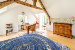 a bedroom with a bed and a table and chairs at Chambre d'hôtes Kerdary in Nivillac +16 photos
