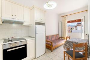 a kitchen with a refrigerator and a table at Olivea Studio 3 in Acharavi