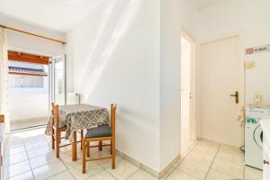 a small dining room with a table and chairs at Olivea Studio 3 in Acharavi
