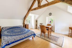 a bedroom with a bed and a table and chairs at Chambre d'hôtes Kerdary in Nivillac