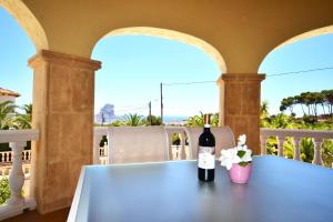 a bottle of wine sitting on a table on a balcony at Villa Cucarres in Calpe