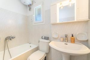 a bathroom with a toilet and a sink and a bath tub at Olivea Studio 3 in Acharavi +18 photos