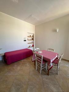 a room with a bed and a table and chairs at Da Katia in Arnesano +8 photos