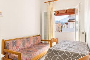 a room with a couch and a table and a window at Olivea Studio 3 in Acharavi