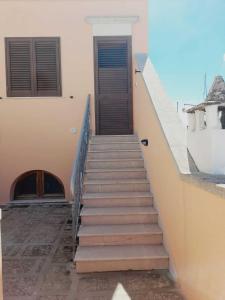 a staircase leading up to a building with a door at Da Katia in Arnesano