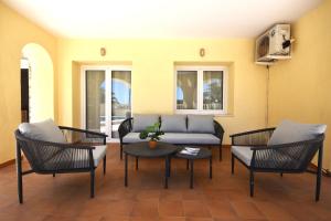 a living room with a couch and chairs and a table at Villa Cucarres in Calpe