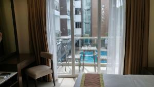 a hotel room with a view of a balcony at Boracay Haven Suites in Boracay