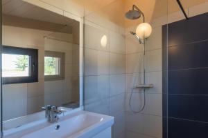 a bathroom with a shower and a sink and a mirror at Villa Luminières I in Sallelles +20 photos