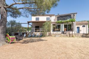 a house with a patio and a tree at Villa Luminières I in Sallelles