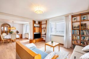 a living room with a couch and a table at Munich Hideaway in Karlsfeld