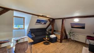 a living room with a couch and a table at Fewo Gipfelstürmer mit Königscard in Nesselwang